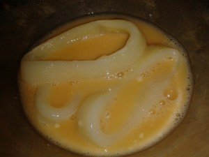 Squid rings in egg wash