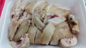 Half a poached chicken, cut in the bone and ready to serve. 