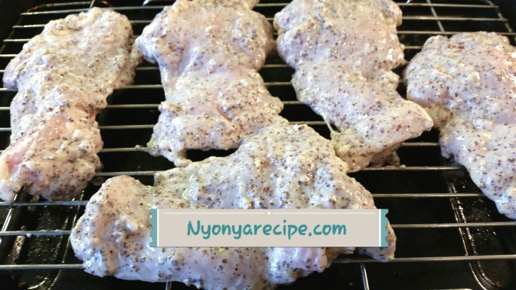 Seasoned chicken thighs ready for the grill. The yogurt gives a natural 'covering' to keep the chicken moist.