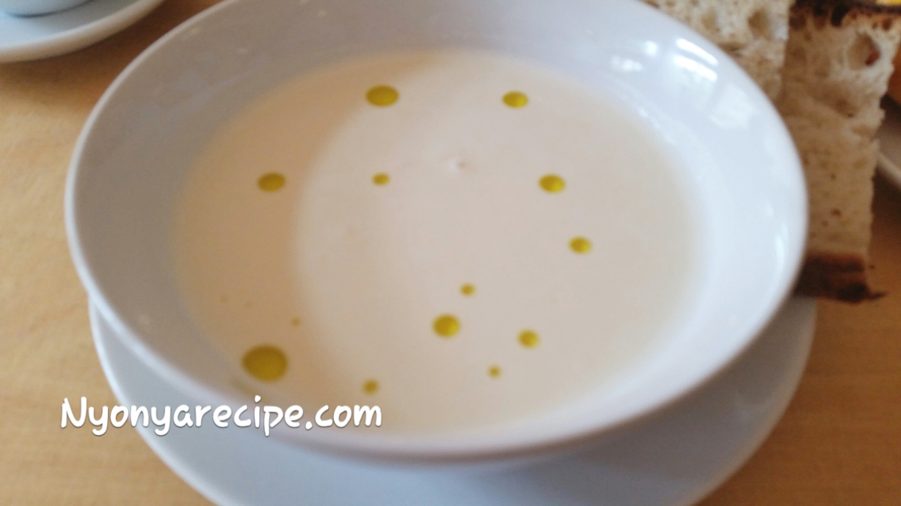Ajo Blanco with droplets of olive oil on the top.