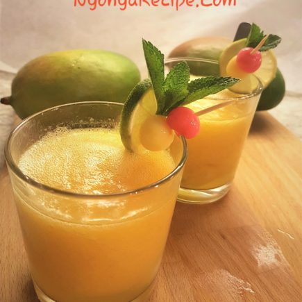 Mango smoothie tang yuan served in glasses, decorated with mint leaves, lime slices and pink and yellow balls.