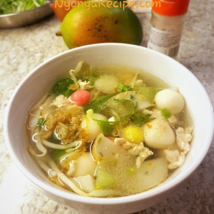 A bowl of savoury Tang Yuan with beansprouts, chicken, vegetables and seasoning.