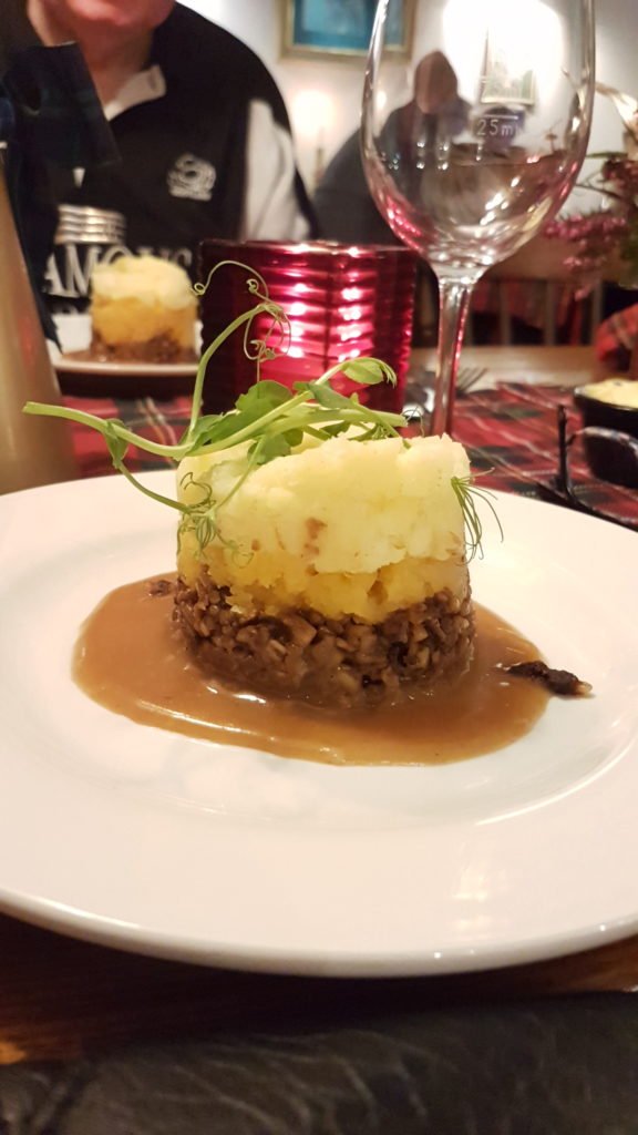 The haggis serves in a posh manner with mash and sauce.
