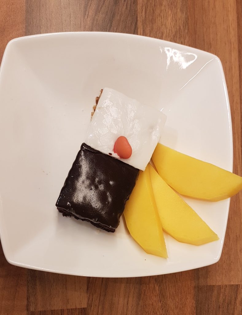 Vegan Carrot cake and chocolate cake served with mango.