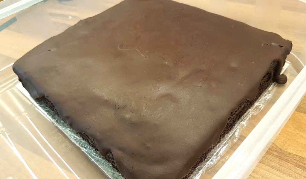 Chocolate cake covered with chocolate glaze.
