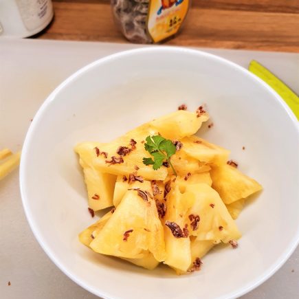 A bowl of freshly cut pin apple with garnishing